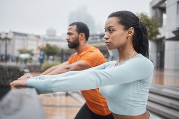 Image showing Fitness, runner and couple stretching in city for workout and health mindset preparation in Chicago, USA. Focused people warm up stretch for urban running, exercise and endurance together.