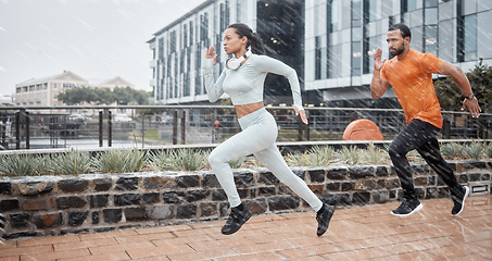 Image showing Running, fitness and couple in the rain with runner energy, speed and fast people doing sport. City, exercise and workout sports in winter doing cardio for a marathon or race athlete training