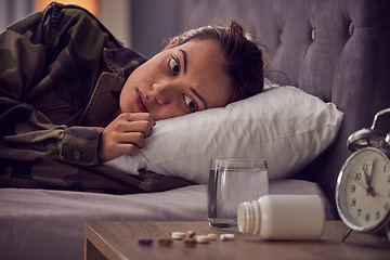 Image showing Depressed woman, bed and medicine for insomnia, mental health and anxiety of military soldier with stress, depression and trauma. Army female in bedroom with ptsd, pills and thinking about drugs