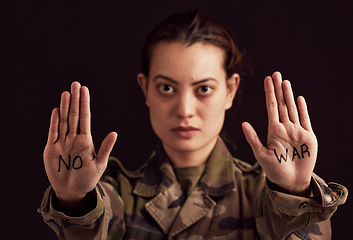 Image showing Soldier portrait and stop hands for war protest of asian woman with political palm statement. Serious, unhappy and army girl frustrated with violence in Ukraine with black studio background.