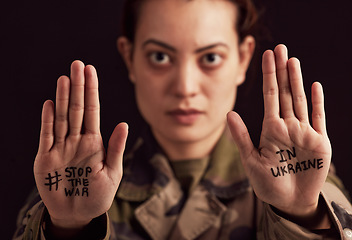 Image showing Ukraine, war and stop with woman soldier showing her hands or palms in protect to military conflict. Army, freedom and politics with a female trooper in support of Ukrainian freedm or rights