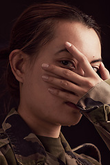 Image showing Soldier woman, mental health and hand on face in studio for depressed, anxiety or stress in war clothes. Military ptsd, trauma memory and army portrait by black background with depression in Ukraine