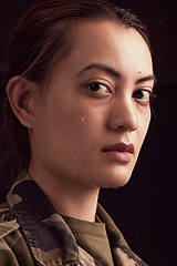 Image showing Crying, soldier trauma and face of sad woman with depression, military ptsd and trauma from army service on studio black background. Portrait of depressed young female veteran with tears from battle