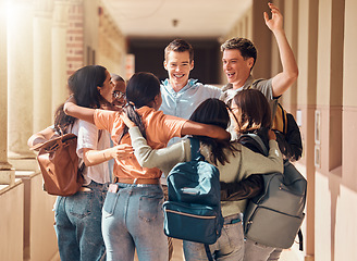 Image showing Group of people, happy students and hug for education celebration, interracial support or study project success. Diversity, university friends celebrate and hugging happiness in building corridor