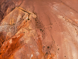 Image showing Aerial shot of the textured yellow nad red mountains resembling the surface of Mars