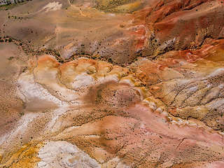 Image showing Aerial shot of the textured yellow nad red mountains resembling the surface of Mars