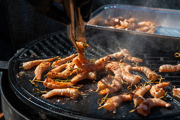 Image showing A professional cook prepares shrimps