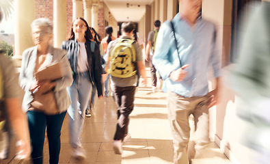 Image showing University, campus and busy students walking to class for learning, studying and education. College, crowd and group of people, men and women at school in hallway or corridor traveling to classroom.