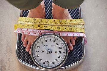 Image showing Top view, feet on scale and tape to lose weight, health and diet for wellness, balance and fitness. Foot, measure and results after training, healthy lifestyle or commitment to exercise and weighing