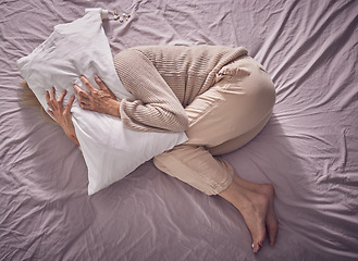 Image showing Top view, depression and sad woman with pillow, bedroom and insomnia, anxiety problem and crying. Depressed, tired and sick lady in sleepless night, fear and mental health stress, scared and burnout