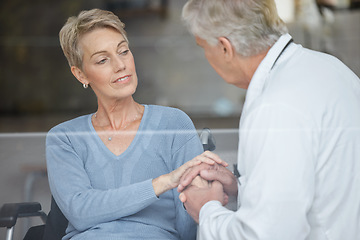 Image showing Disability patient, holding hands and doctor with help, support and trust in physical therapy, healthcare and therapy service. Medical worker, empathy hand holding and consulting woman in wheelchair