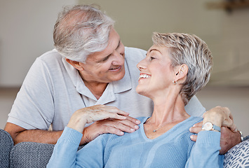 Image showing Love, senior couple and relax on a sofa, smile and happy while sharing intimate moment, bond and romance in living room. Happy family, retirement and senior embrace on a couch, in love and relaxing