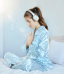 Image showing Woman, music headphones or namaste meditation in house bedroom, home or hotel for mental health, stress management or zen. Calm, peace or yogi listening to relax radio podcast in mind prayer training