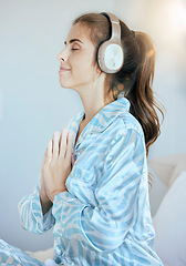 Image showing Headphones, prayer or woman in meditation in bedroom streaming relaxing zen music, yoga podcast or radio at home. Morning, peace or calm spiritual girl praying for mindfulness, health or wellness