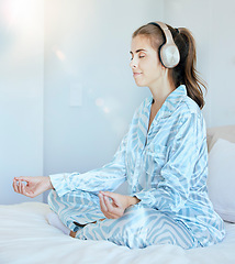 Image showing Yoga, meditation or zen woman in bedroom with headphones streaming relaxing radio, calm music or podcast. Peace, mental health or spiritual girl in lotus pose to meditate for mindfulness or wellness