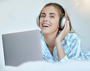 Image showing Woman, student and headphones with laptop for music, streaming and learning online with happiness, education podcast and technology. Academic audio, listening portrait and sound, radio and relax.