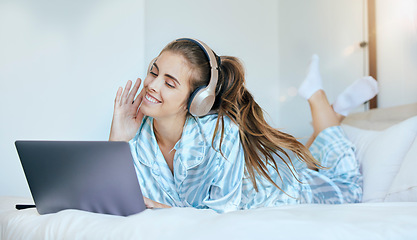 Image showing Woman, headphones and relax on laptop in bedroom to download movies, online show and media entertainment at home. Happy young female, music and computer for streaming subscription, podcast and audio