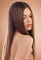 Image showing Woman, beauty and hair care in studio for shine, glow and long straight texture on brown background. Young model, hair style and aesthetic cosmetics, beauty salon and facial makeup transformation