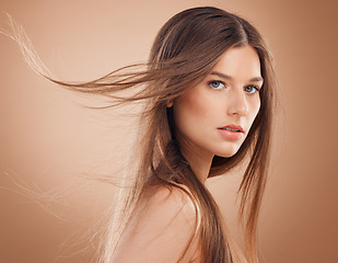 Image showing Woman, face glow or windy hair on studio background in keratin treatment, dermatology health, care or collagen wellness. Portrait, brunette beauty model or facial makeup cosmetics for Canada skincare