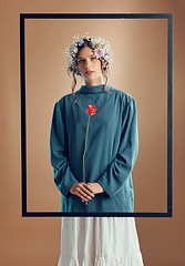 Image showing Woman, floral crown and studio with frame, rose or beauty for fashion in portrait by background. Model, girl and flowers in spring, clothes or design with red rose plant in hands by studio background