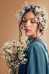 Image showing Beauty, makeup and woman with flower, crown and skincare in studio, wellness and creative on brown background mockup. Flowers, girl and model with nature aesthetic, luxury and eco friendly product
