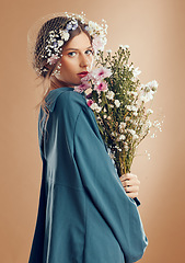 Image showing Aesthetic woman, beauty and flowers on studio background for cosmetics, skincare and dermatology during spring in Amish culture. Portrait of female model with flower for natural nature fashion style