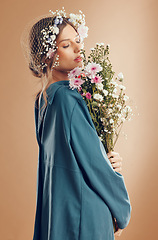 Image showing Floral crown, fashion and woman with flowers in studio isolated on a brown background. Beauty, makeup and aesthetics of female model from Canada in dress with plants or organic cosmetics for skincare