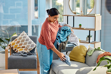 Image showing Woman, laundry and house for cleaning, happy and fresh scent in living room. Latino female, maid and cleaner with chores, clothes and smile for housekeeping, home and clean in lounge for household.