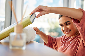 Image showing Cleaning, home and woman dusting book shelf to remove dust and dirt. Spring cleaning, cleaning service and happy female cleaner, maid or housekeeper with duster for furniture, chores and hygiene.