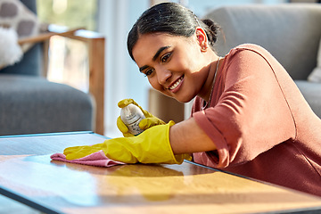 Image showing Woman, wipe table and spray with cloth, for hygiene and disinfectant in home. Cleaner, maid or female cleaning service for bacteria, dust on furniture and housekeeping with rag, surface and detergent