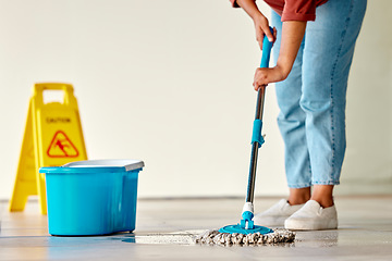 Image showing Cleaning, sign and woman mopping floor in office for hygiene, health and wellness. Spring cleaning, service and janitor, cleaner and female with mop, water bucket and caution wet floor warning notice