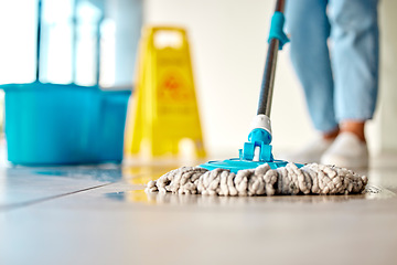 Image showing Mop, cleaner and washing wet floor for hygiene, disinfection or sanitary area for cleanliness at the workplace. Housekeeper cleaning dirty flooring for sanitization, water or wash indoors