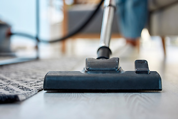 Image showing Vacuum cleaner, floor closeup and home living room for hygiene, spring cleaning and dust by blurred background. Cleaning, dirt and flooring with vacuum appliance, carpet and wood in apartment in Rome