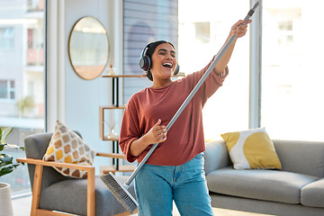 Image showing Dance, radio or woman cleaning with music for singing or listening to a song with broom as a guitar at home. Relax, freedom or happy Indian girl cleaner streaming audio on headphones or housekeeping