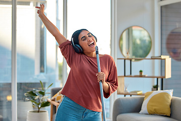 Image showing Cleaning, singing and woman dance to music for fun, energy and happiness while doing housekeeping, mop and broom in living room. Spring cleaning, headphones and happy dancing at home with freedom