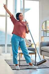 Image showing Woman, singing and dancing while cleaning living room for fun domestic work, hygiene and cleanliness at home. Happy female listening to music enjoying housework, sing and dance with broom stick