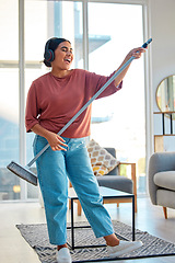 Image showing Woman, headphones and cleaning living room with music for home spring cleaning, housekeeping or sweeping floor. Singing karaoke, online podcast and happy cleaner or housework with broom in apartment