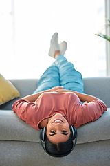 Image showing Woman, sofa and upside down with headphones, smile or music in portrait to relax in lounge. Happy lady, couch or audio for happiness, streaming podcast or internet radio in home living room in Mexico