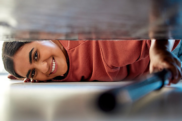 Image showing Woman cleaning under a bed in bedroom with vacuum for the floor to clean dust, dirt or bacteria. Happy, smile and portrait of housewife or maid disinfecting the ground of house while spring cleaning.