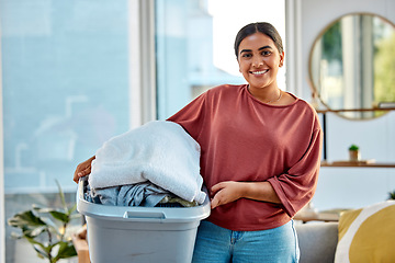 Image showing Woman, laundry and portrait smile for clean clothes, personal hygiene or housework at home. Happy female holding washing basket of material for cleaning, chores or housekeeping in the living room