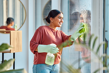 Image showing Woman, cleaning and window st home for dirt, dust and bacteria with a cloth and spray bottle for shine and clean view. Happy female cleaner or maid with a smile using chemical on apartment glass