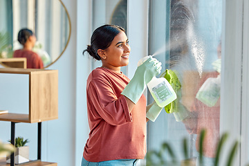 Image showing Woman, cleaning and spray product of a cleaner washing a window with a smile in home. Happy working maid use a home hygiene bottle and cloth to disinfect the house furniture with a sanitizer bottle