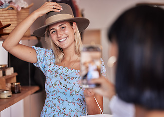 Image showing Fashion, friends shopping and taking pictures with phone for happy memory, profile picture or social media. Retail mall, sales deals and women or girls trying hats and taking mobile smartphone photo.