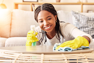 Image showing Smile, spray bottle and black woman cleaning table with gloves and alcohol solution in living room. Coffee table, spring cleaning and happy woman wiping dust in home for safety from bacteria and germ