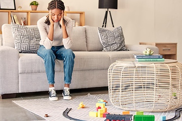 Image showing Black woman, headache and mental health, stress and anxiety while depressed on sofa in home living room. Stressed female, mistake and sad, head pain and tired of burnout problems on couch in home