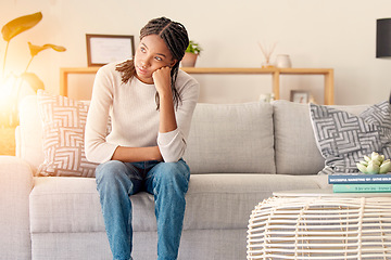 Image showing Stress, thinking or burnout black woman in living room. of house or home with sun lens flare light on sofa. Focus, sunshine or girl sitting on lounge couch with depression, anxiety or mental health