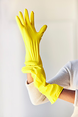 Image showing Cleaning gloves, hands and woman in home ready to sanitize for hygiene, wellness and health. Spring cleaning, cleaning service and female cleaner preparing to remove dust, germs or bacteria in house