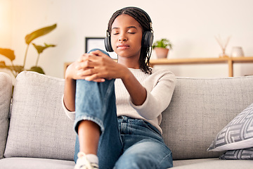 Image showing Music headphones, peace and relax girl listening to wellness podcast for calm mindset, mindfulness or audio meditation. Easy meditating, living room sofa or gen z black woman streaming zen radio song