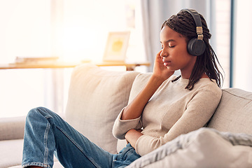 Image showing Relax, music and black woman with calm podcast, wellness sound and tired with radio on the sofa. Zen, sleeping and girl with headphones listening to an audio for mindset and peace in the living room