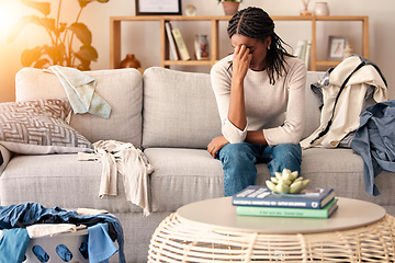 Image showing Black woman, stress and headache in depression on sofa from dirty living room or goblin mode at home. Stressed African American female tired, frustrated or suffering in mental health burnout on couch